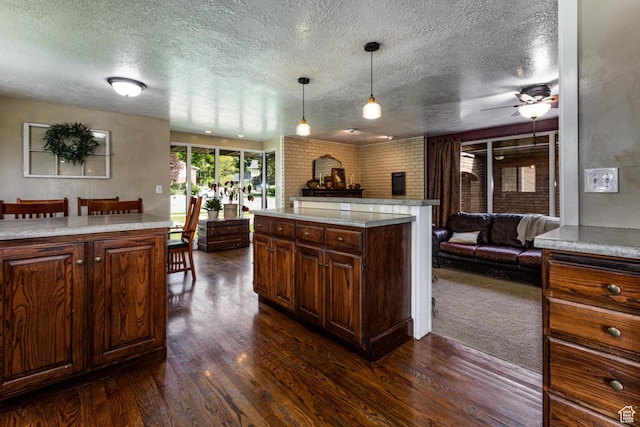 453 Sheridan Cir, Centerville, UT 84014 - kitchen featuring open floor plan, dark wood-style floors, a textured ceiling, light countertops, and brick wall