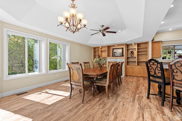13032 S 1300 W, Riverton, UT 84065 - dining area featuring a tray ceiling, light wood-style floors, a chandelier, recessed lighting, and ceiling fan