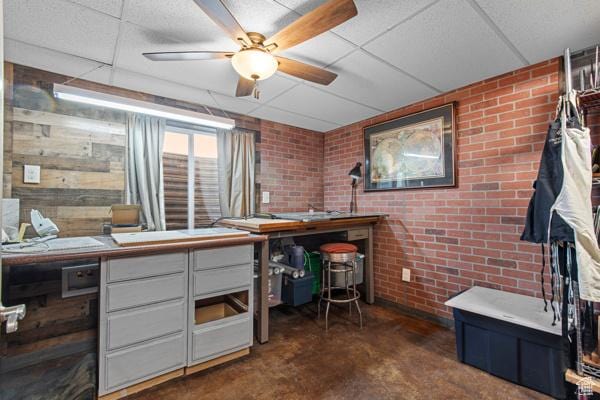 13032 S 1300 W, Riverton, UT 84065 - office area featuring finished concrete floors, brick wall, ceiling fan, and a drop ceiling