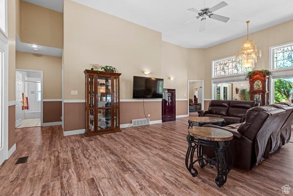 13032 S 1300 W, Riverton, UT 84065 - living area featuring a towering ceiling, wood finished floors, and ceiling fan