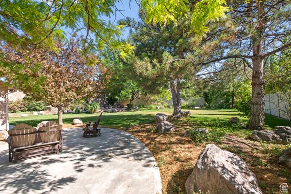13032 S 1300 W, Riverton, UT 84065 - view of property's community with a patio area and a lawn