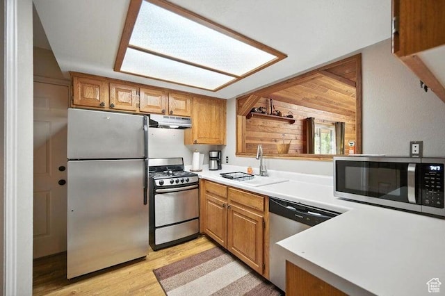 10 S 900 E, Pine Valley, UT 84781 - kitchen featuring stainless steel appliances, under cabinet range hood, light wood-style flooring, light countertops, and brown cabinetry