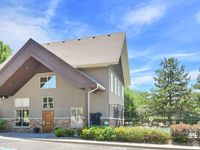 4988 S Timber Way E Unit 206, Millcreek, UT 84117 - view of home's exterior featuring stone siding and stucco siding