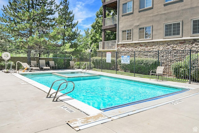 4988 S Timber Way E Unit 206, Millcreek, UT 84117 - view of swimming pool with a patio and a pool with connected hot tub