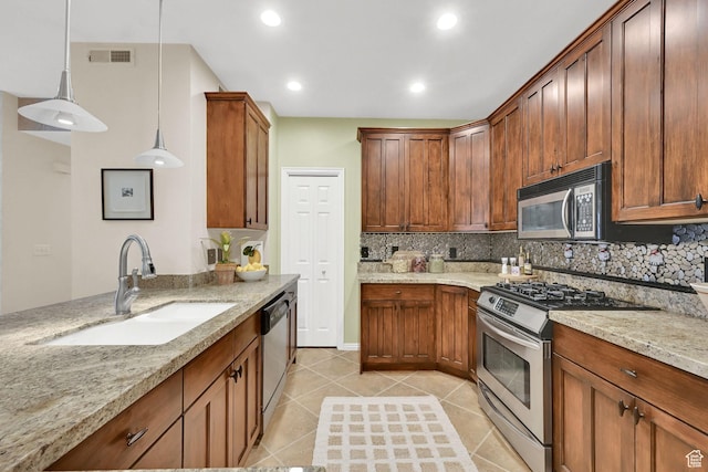 4988 S Timber Way E Unit 206, Millcreek, UT 84117 - kitchen featuring appliances with stainless steel finishes, light tile patterned flooring, tasteful backsplash, light stone countertops, and decorative light fixtures