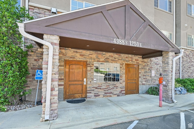 4988 S Timber Way E Unit 206, Millcreek, UT 84117 - doorway to property with stone siding
