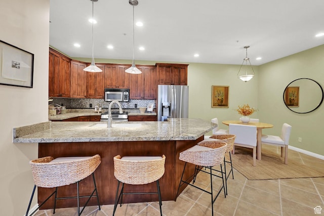 4988 S Timber Way E Unit 206, Millcreek, UT 84117 - kitchen with stainless steel appliances, tasteful backsplash, a peninsula, light tile patterned flooring, and light stone counters