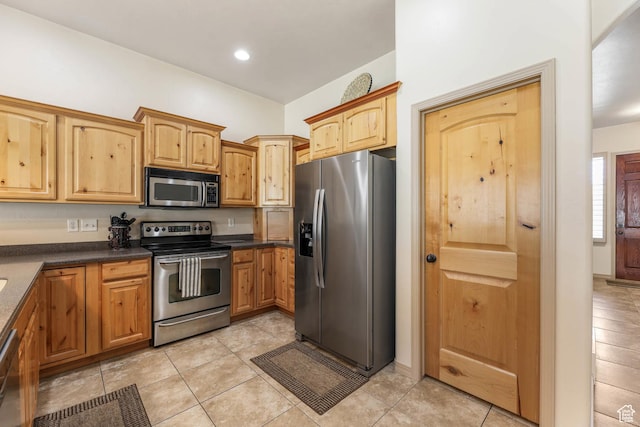 1524 W Foliage Ln, South Jordan, UT 84095 - kitchen featuring stainless steel appliances, dark countertops, light tile patterned flooring, and recessed lighting