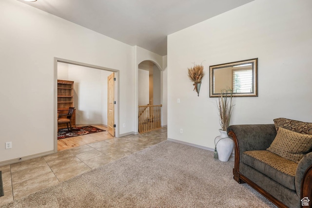 1524 W Foliage Ln, South Jordan, UT 84095 - living area featuring light tile patterned floors, arched walkways, and light colored carpet