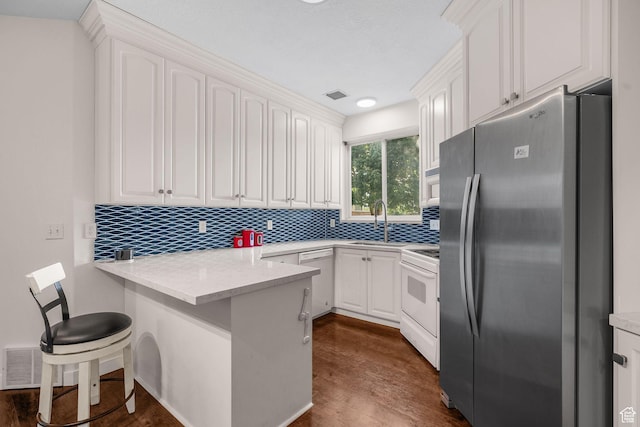 9566 N 4500 W, Cedar Hills, UT 84062 - kitchen featuring white appliances, a peninsula, white cabinetry, and decorative backsplash