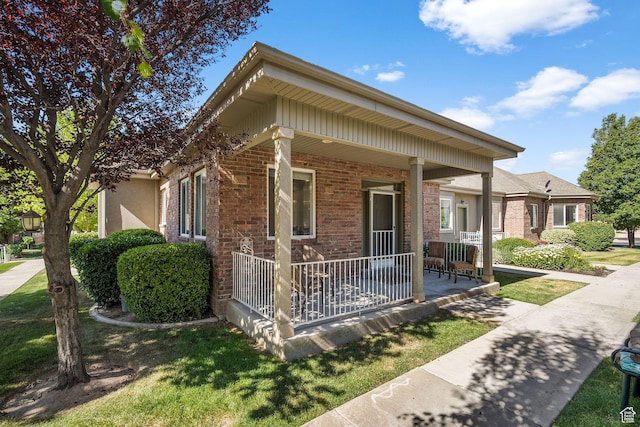 9566 N 4500 W, Cedar Hills, UT 84062 - view of front of home featuring a porch and brick siding