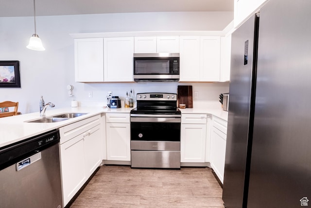 3722 W 1440 N Unit F202, Lehi, UT 84043 - kitchen featuring appliances with stainless steel finishes, light wood-type flooring, light countertops, white cabinetry, and pendant lighting