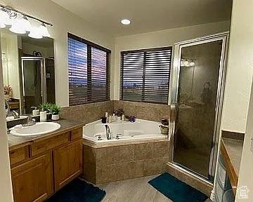 3462 Heyward Ct, Eagle Mountain, UT 84043 - bathroom with vanity, a garden tub, and a stall shower
