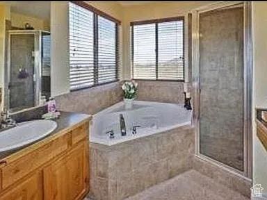 3462 Heyward Ct, Eagle Mountain, UT 84043 - full bath with plenty of natural light, a shower stall, vanity, and a garden tub