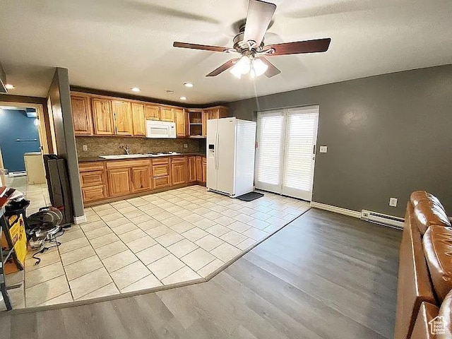3462 Heyward Ct, Eagle Mountain, UT 84043 - kitchen with white appliances, a ceiling fan, dark countertops, light wood-style flooring, and baseboard heating