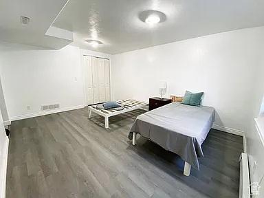 3462 Heyward Ct, Eagle Mountain, UT 84043 - bedroom featuring a baseboard heating unit and wood finished floors