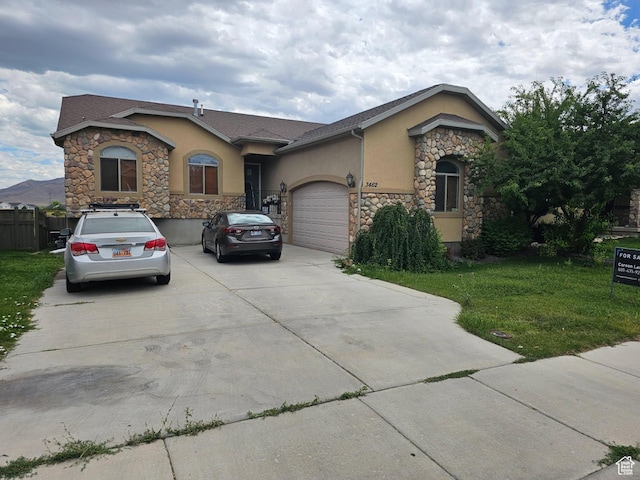 3462 Heyward Ct, Eagle Mountain, UT 84043 - ranch-style home featuring stone siding, stucco siding, concrete driveway, and a garage