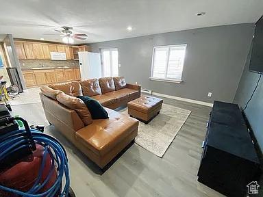 3462 Heyward Ct, Eagle Mountain, UT 84043 - living room featuring a ceiling fan, recessed lighting, and light wood-style floors