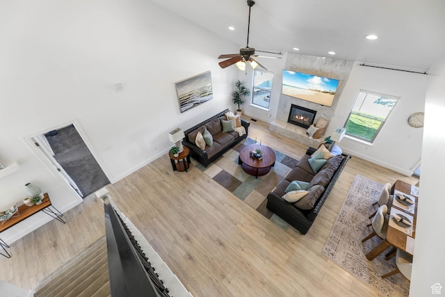 1692 N Sage Ln, Saratoga Springs, UT 84045 - living room with wood finished floors, recessed lighting, a ceiling fan, a fireplace, and a high ceiling
