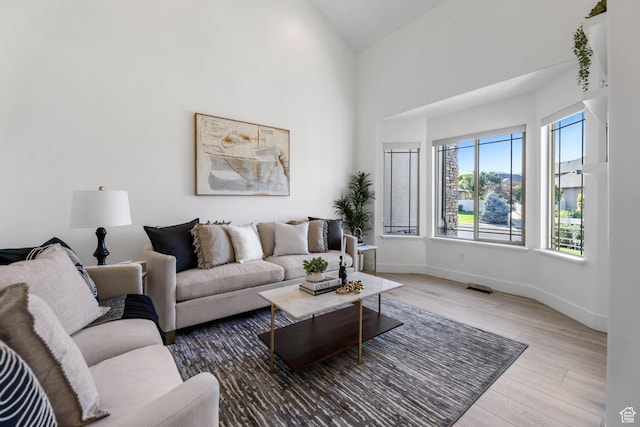 1692 N Sage Ln, Saratoga Springs, UT 84045 - living area featuring wood finished floors and a towering ceiling
