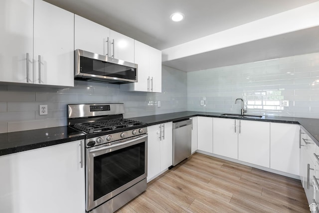 1692 N Sage Ln, Saratoga Springs, UT 84045 - kitchen with stainless steel appliances, backsplash, white cabinetry, recessed lighting, and light wood-style floors