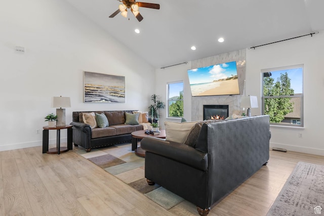 1692 N Sage Ln, Saratoga Springs, UT 84045 - living area featuring a large fireplace, recessed lighting, ceiling fan, light wood finished floors, and high vaulted ceiling