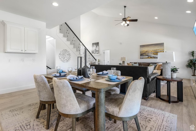 1692 N Sage Ln, Saratoga Springs, UT 84045 - dining room with stairs, a ceiling fan, light wood-style flooring, recessed lighting, and high vaulted ceiling