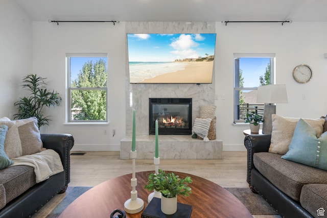 1692 N Sage Ln, Saratoga Springs, UT 84045 - living area featuring track lighting, a glass covered fireplace, wood finished floors, and healthy amount of natural light