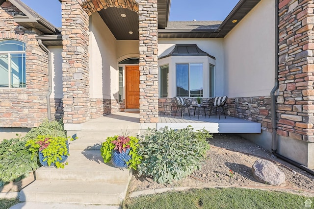 1692 N Sage Ln, Saratoga Springs, UT 84045 - doorway to property featuring covered porch, stucco siding, and stone siding