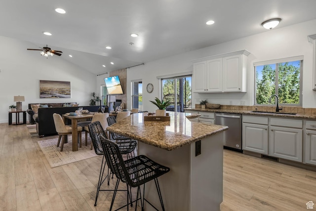 1692 N Sage Ln, Saratoga Springs, UT 84045 - kitchen featuring stainless steel dishwasher, a breakfast bar, light wood-type flooring, a ceiling fan, and recessed lighting
