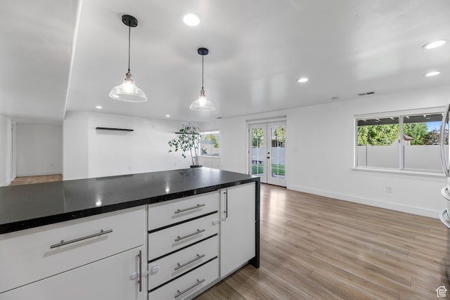 1692 N Sage Ln, Saratoga Springs, UT 84045 - kitchen with recessed lighting, french doors, white cabinets, light wood-type flooring, and dark countertops