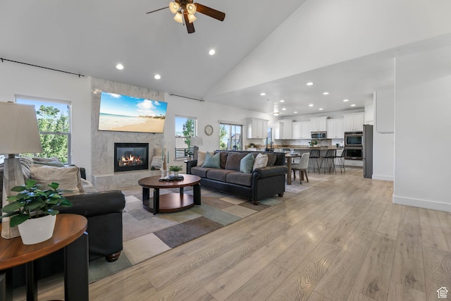 1692 N Sage Ln, Saratoga Springs, UT 84045 - living area with recessed lighting, ceiling fan, light wood-style flooring, a stone fireplace, and high vaulted ceiling
