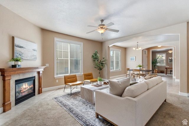 5549 W Parkway W Dr, Highland, UT 84003 - living room with arched walkways, ceiling fan, a tile fireplace, and light carpet