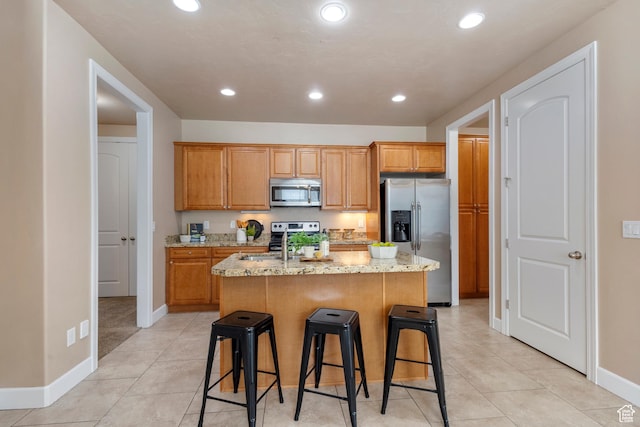 5549 W Parkway W Dr, Highland, UT 84003 - kitchen featuring stainless steel appliances, an island with sink, light stone countertops, a breakfast bar, and recessed lighting