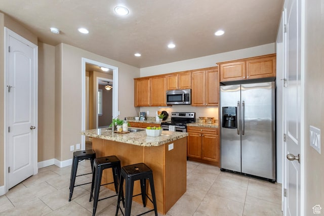 5549 W Parkway W Dr, Highland, UT 84003 - kitchen with stainless steel appliances, a center island, light stone counters, recessed lighting, and light tile patterned floors
