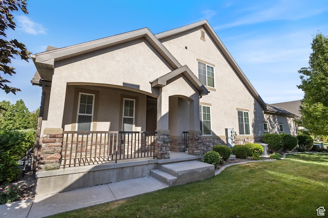 5549 W Parkway W Dr, Highland, UT 84003 - view of front of home featuring stucco siding, covered porch, stone siding, and a front yard
