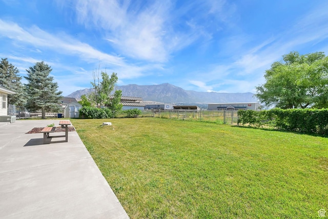 3112 N Pelican Dr, Farr West, UT 84404 - view of yard with a mountain view, a storage unit, and a patio area