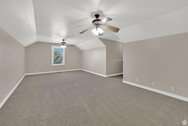 3112 N Pelican Dr, Farr West, UT 84404 - bonus room featuring dark carpet, vaulted ceiling, and a ceiling fan