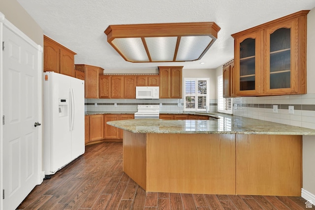 3112 N Pelican Dr, Farr West, UT 84404 - kitchen with white appliances, a peninsula, light stone countertops, glass insert cabinets, and backsplash