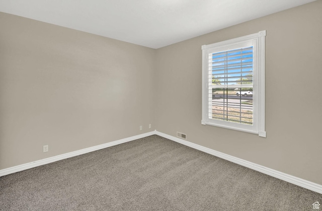 3112 N Pelican Dr, Farr West, UT 84404 - empty room featuring dark carpet and baseboards