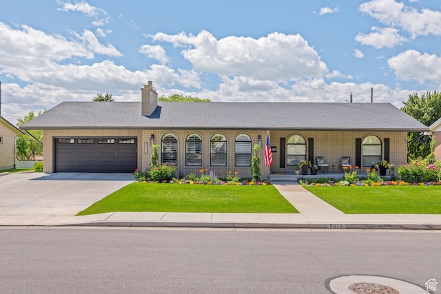 2677 N 700 E, Provo, UT 84604 - view of front of house with an attached garage, a front yard, concrete driveway, and a porch