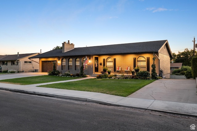 2677 N 700 E, Provo, UT 84604 - ranch-style home with driveway, a chimney, a yard, a garage, and a porch