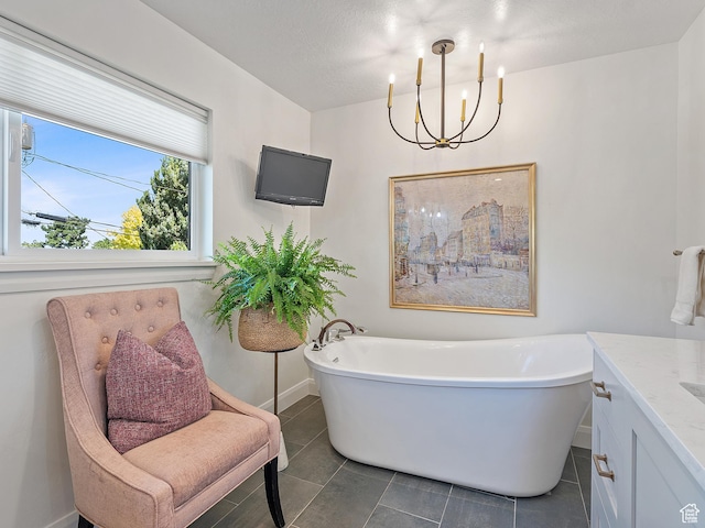 2677 N 700 E, Provo, UT 84604 - full bathroom featuring a freestanding bath, vanity, a chandelier, and tile patterned flooring