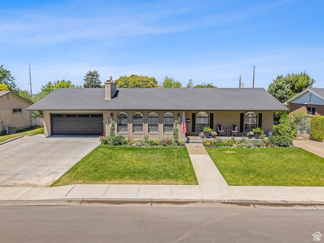2677 N 700 E, Provo, UT 84604 - ranch-style home with covered porch, concrete driveway, an attached garage, a front lawn, and a chimney