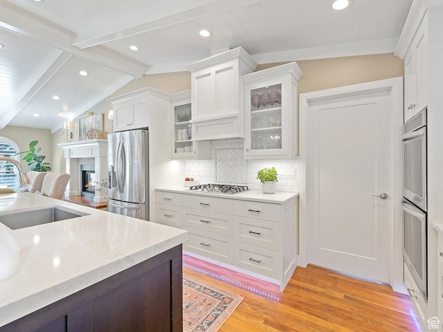 2677 N 700 E, Provo, UT 84604 - kitchen featuring appliances with stainless steel finishes, light wood finished floors, recessed lighting, white cabinetry, and decorative backsplash