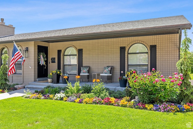 2677 N 700 E, Provo, UT 84604 - doorway to property featuring covered porch, a lawn, a chimney, and a shingled roof
