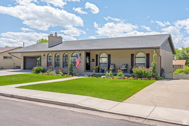 2677 N 700 E, Provo, UT 84604 - ranch-style house with concrete driveway, a porch, a front lawn, a chimney, and a garage