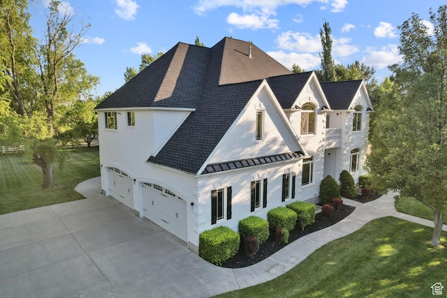 6373 W 10500 N, Highland, UT 84003 - view of side of home featuring a standing seam roof, a shingled roof, concrete driveway, an attached garage, and a yard