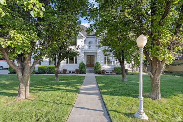 6373 W 10500 N, Highland, UT 84003 - view of property hidden behind natural elements featuring french doors, a front lawn, and a balcony