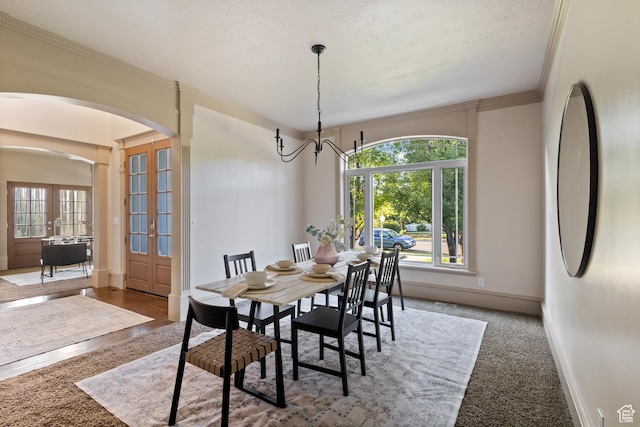6373 W 10500 N, Highland, UT 84003 - dining area featuring arched walkways, french doors, crown molding, and a chandelier